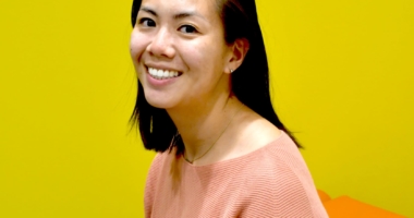 photo of Katherine Wiryaman smiling in front of a yellow background